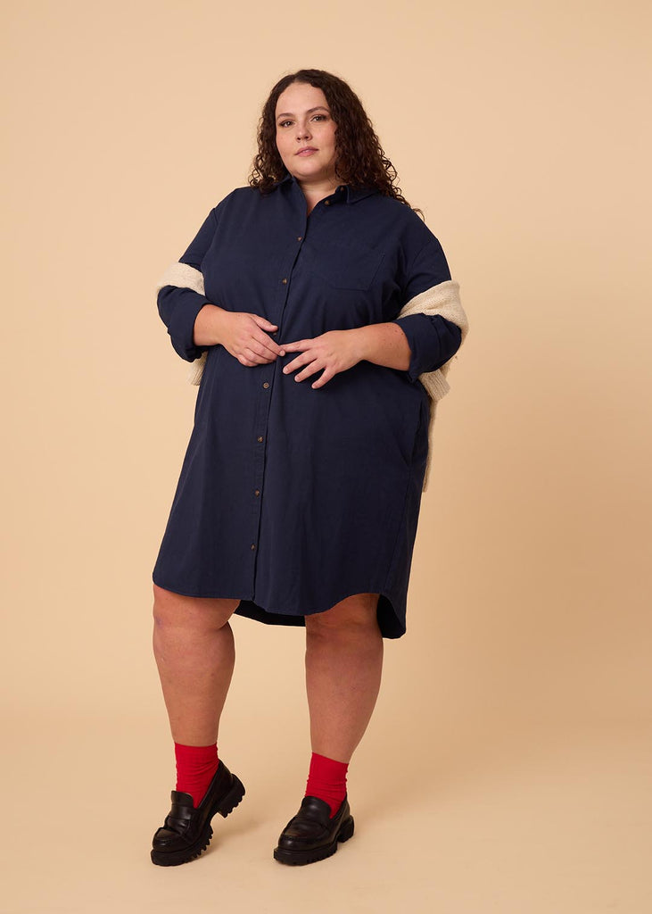 plus size person in a navy shirt dress