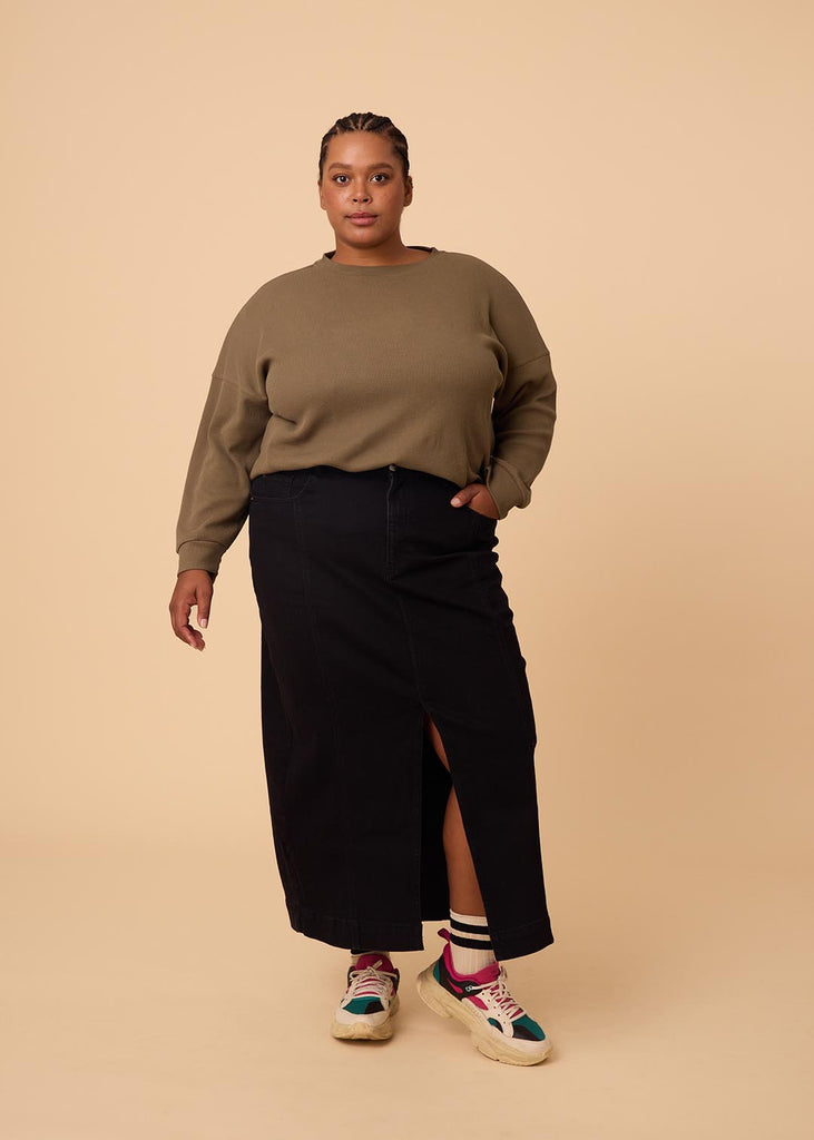 plus size woman wearing olive green long sleeve waffle top