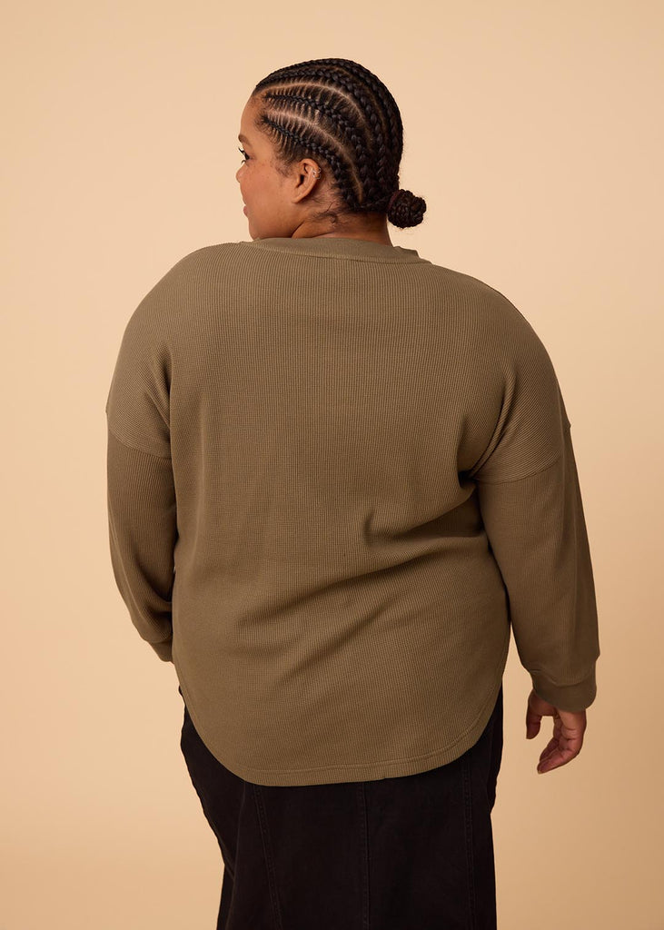 plus size woman wearing olive green long sleeve waffle top