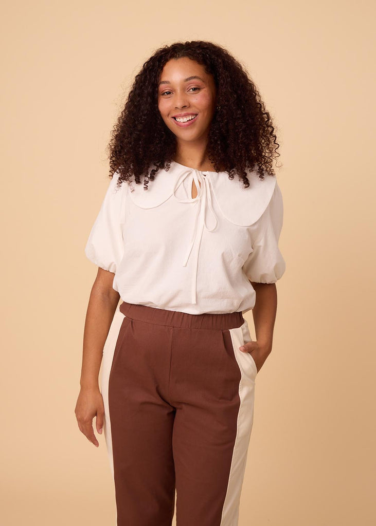 a straight sized woman wearing brown and white pants