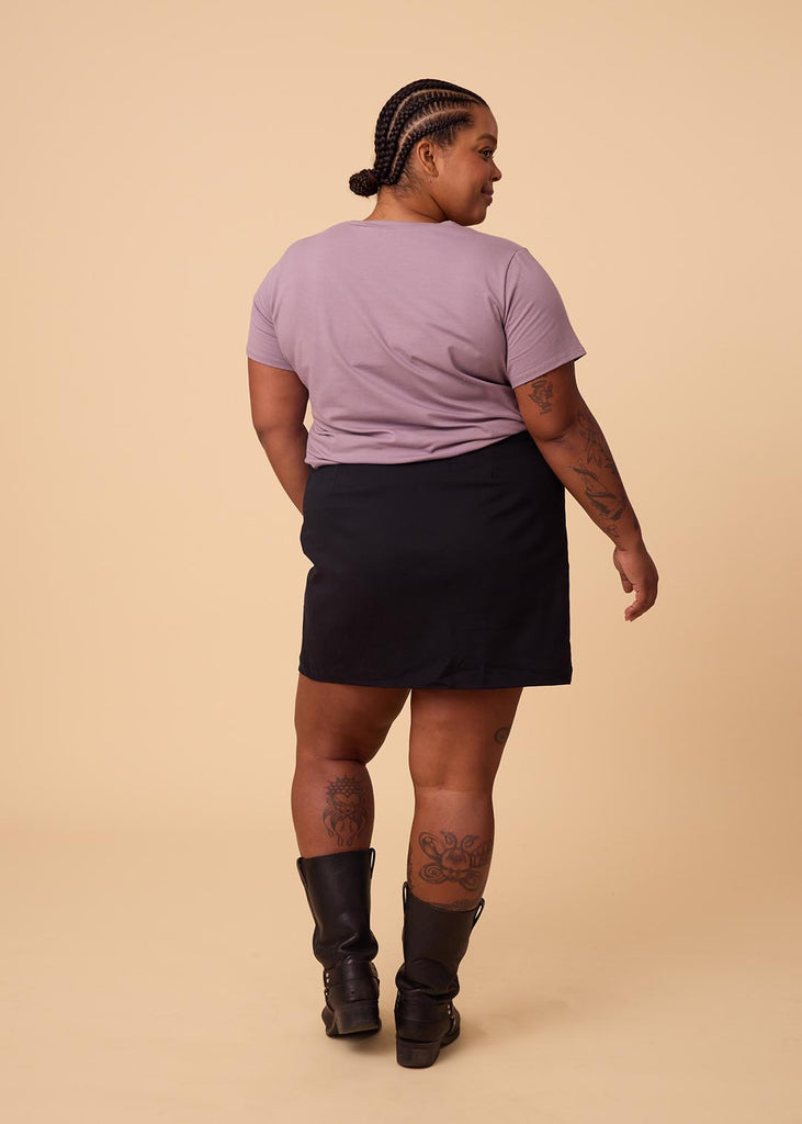 plus size woman in lavender tee shirt