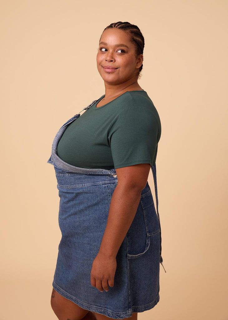 plus size woman in a deep green tee shirt