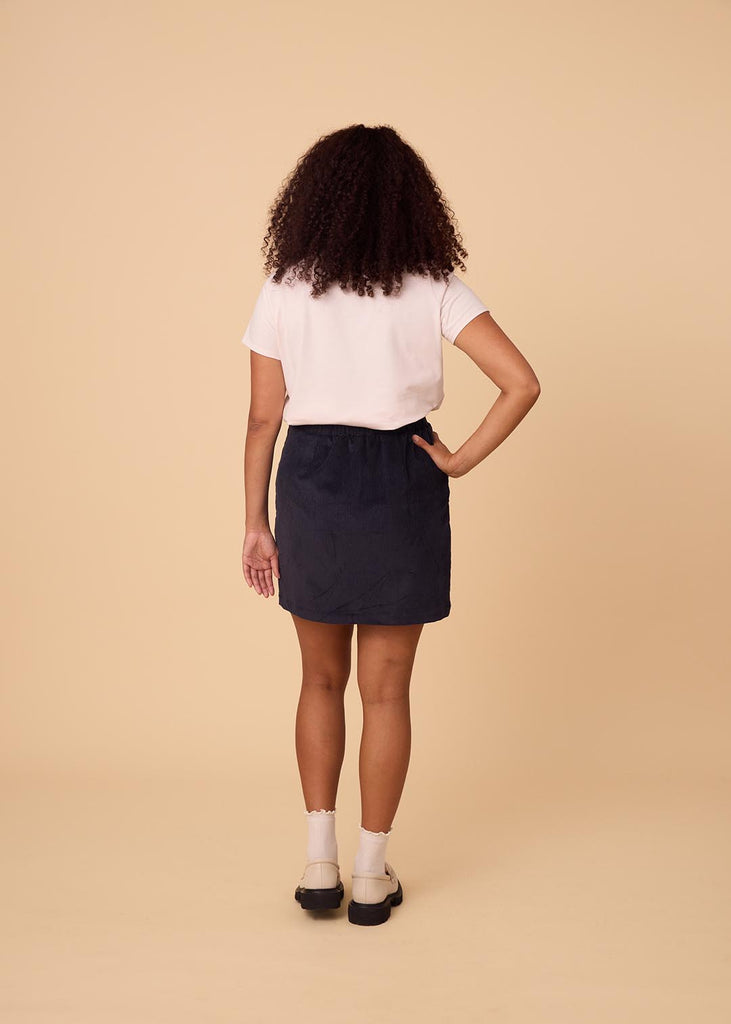 a straight size woman wearing a navy miniskirt