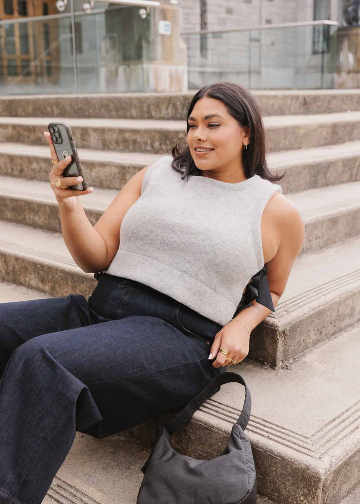 a plus size woman wearing a grey wool vest