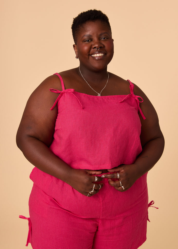 a plus size person wearing a matching pink set