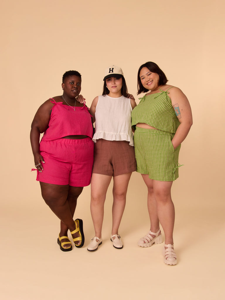 a shot of three people wearing colourful shorts and tank tops