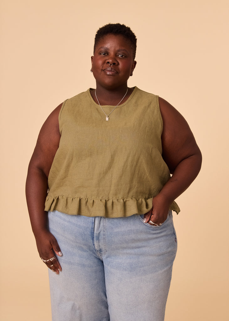 a plus size person wearing a green tank top