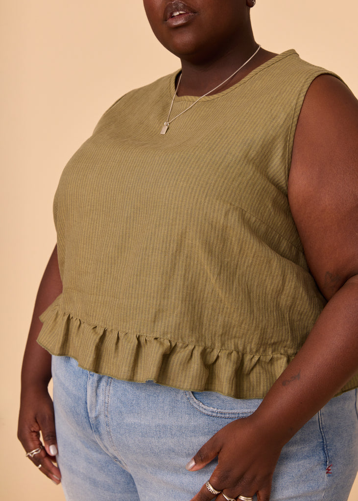 a plus size person wearing a green tank top