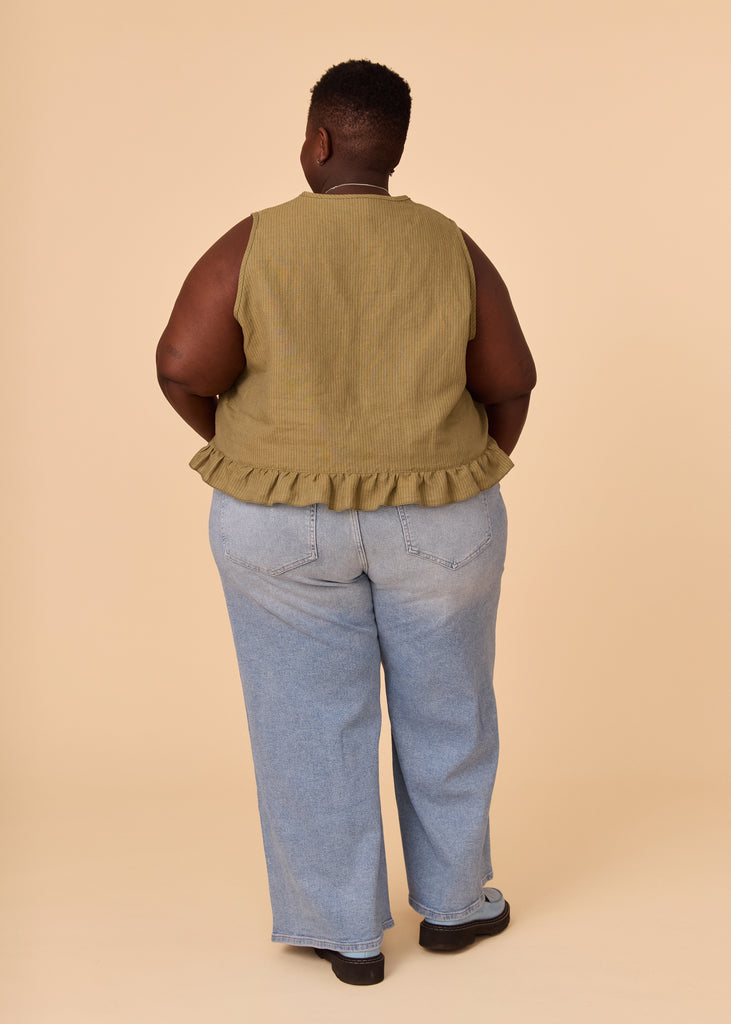 a plus size person wearing a green tank top