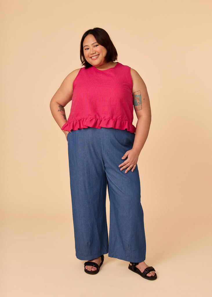 a mid size woman wearing a pink tank top