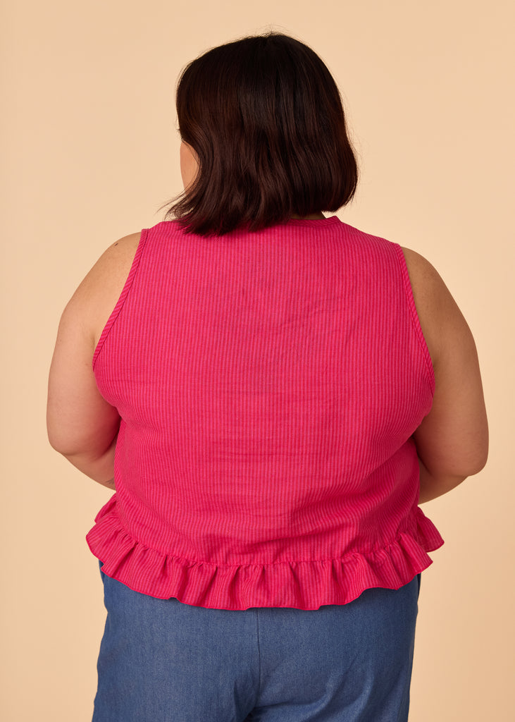 a mid size person wearing a pink tank top