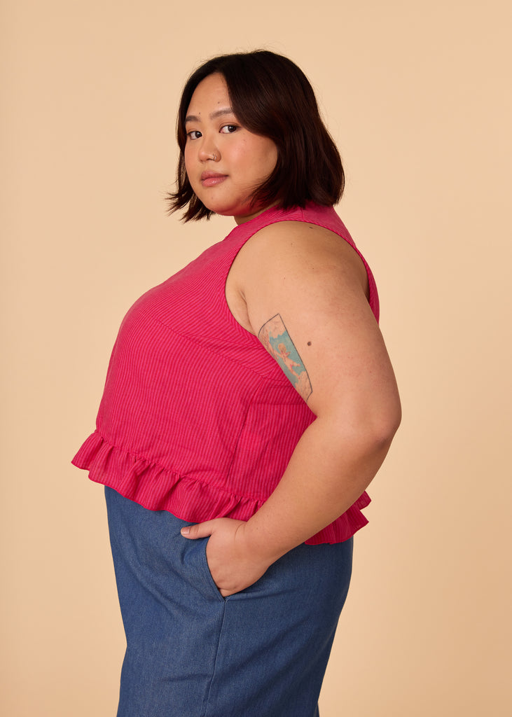 a mid size person wearing a pink tank top