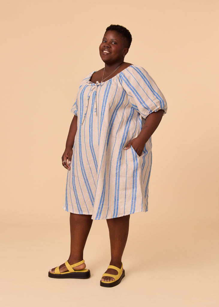 a plus size person wearing a blue striped sundress