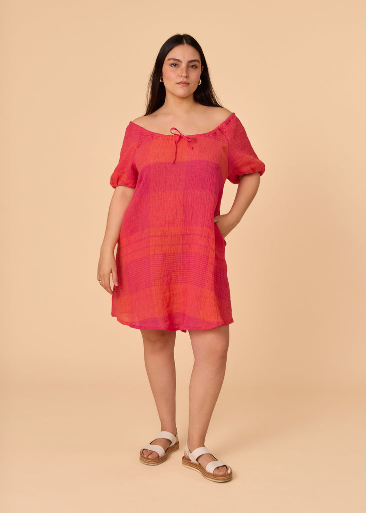 a straight size women wearing a pink and orange sundress