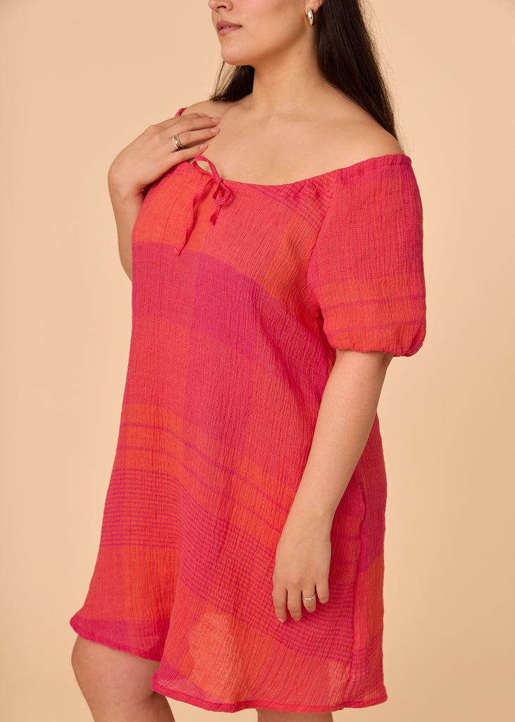 a straight size women wearing a pink and orange sundress