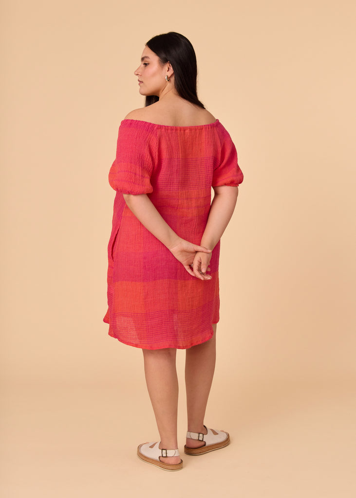 a straight size women wearing a pink and orange sundress