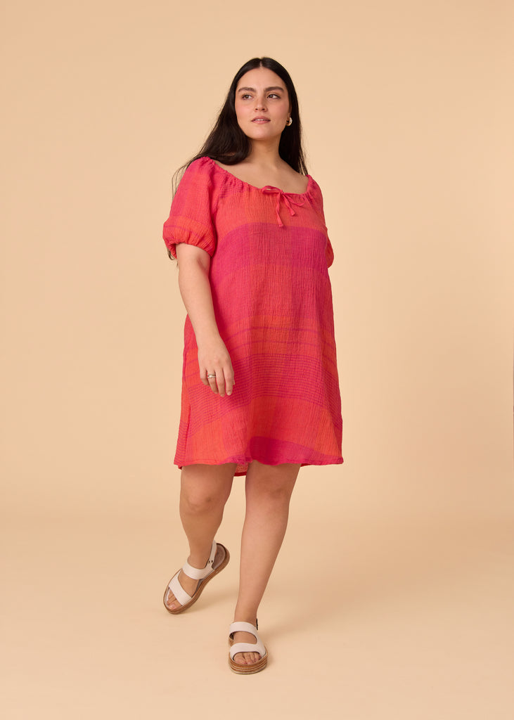 a straight size women wearing a pink and orange sundress