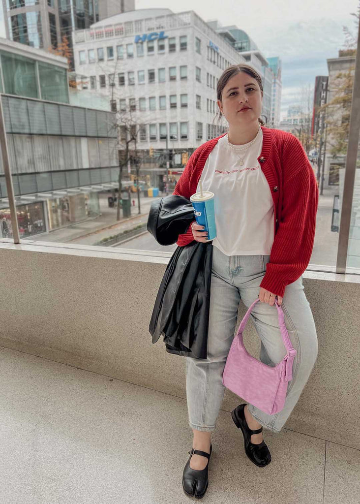 a plus size woman wearing a white cropped graphic tee