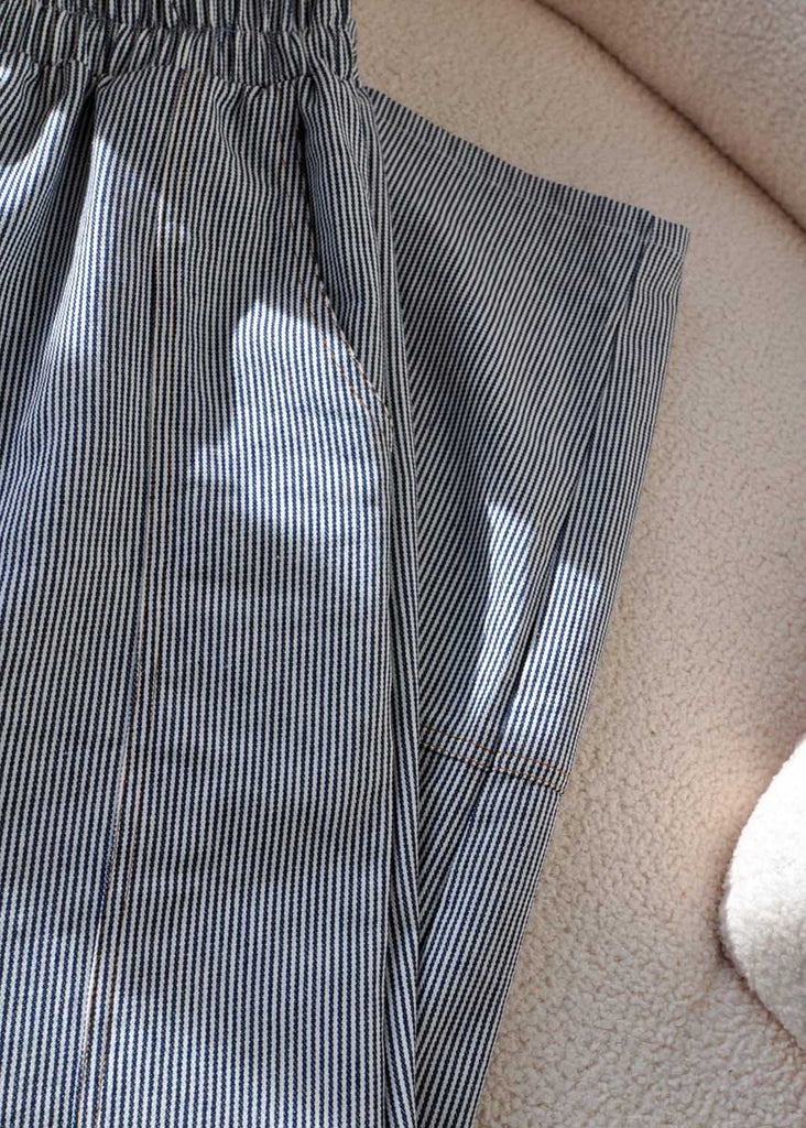 a close up shot of striped utility pants, showing the seam details