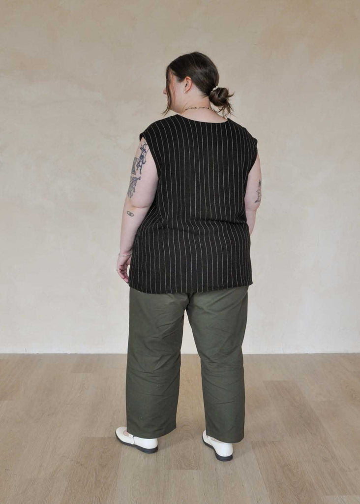 a plus size woman wearing green utility pants