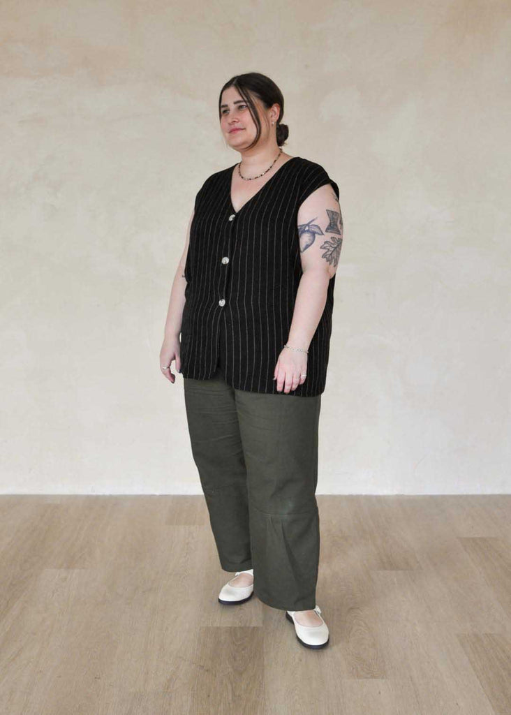 a plus size woman wearing green utility pants