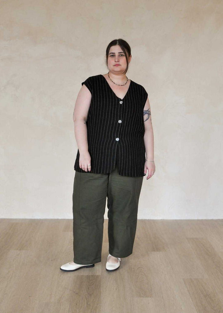 a plus size woman wearing green utility pants