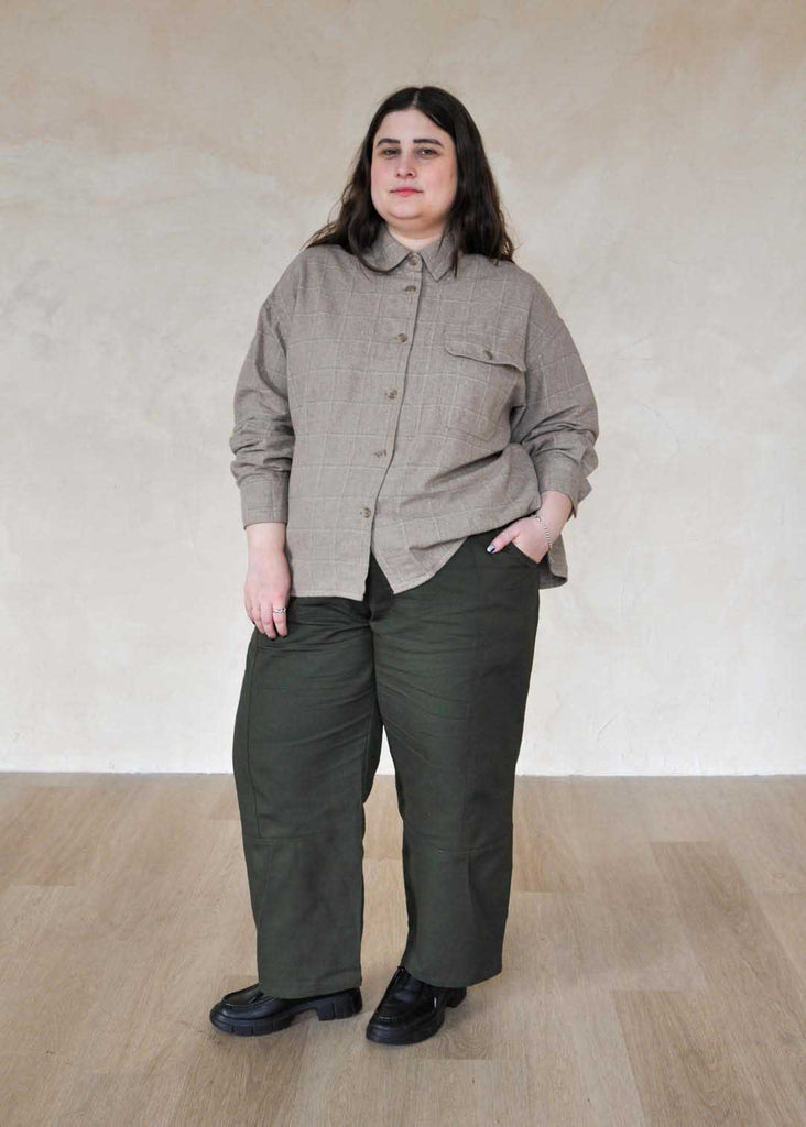 a plus size woman wearing green utility pants