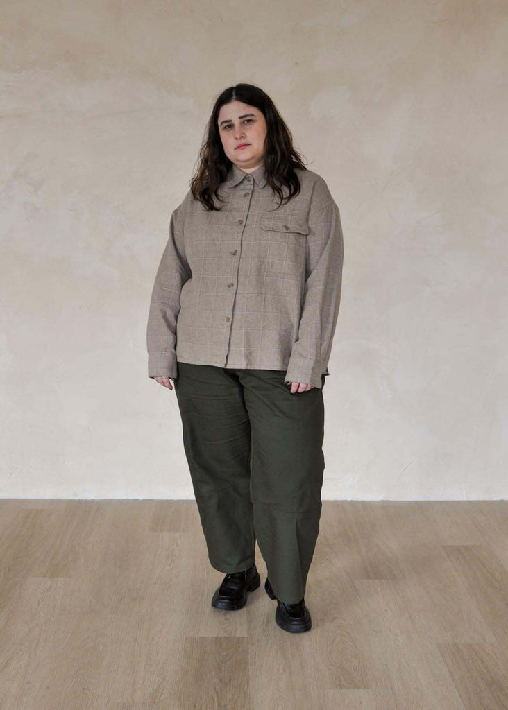 a plus size woman wearing green utility pants