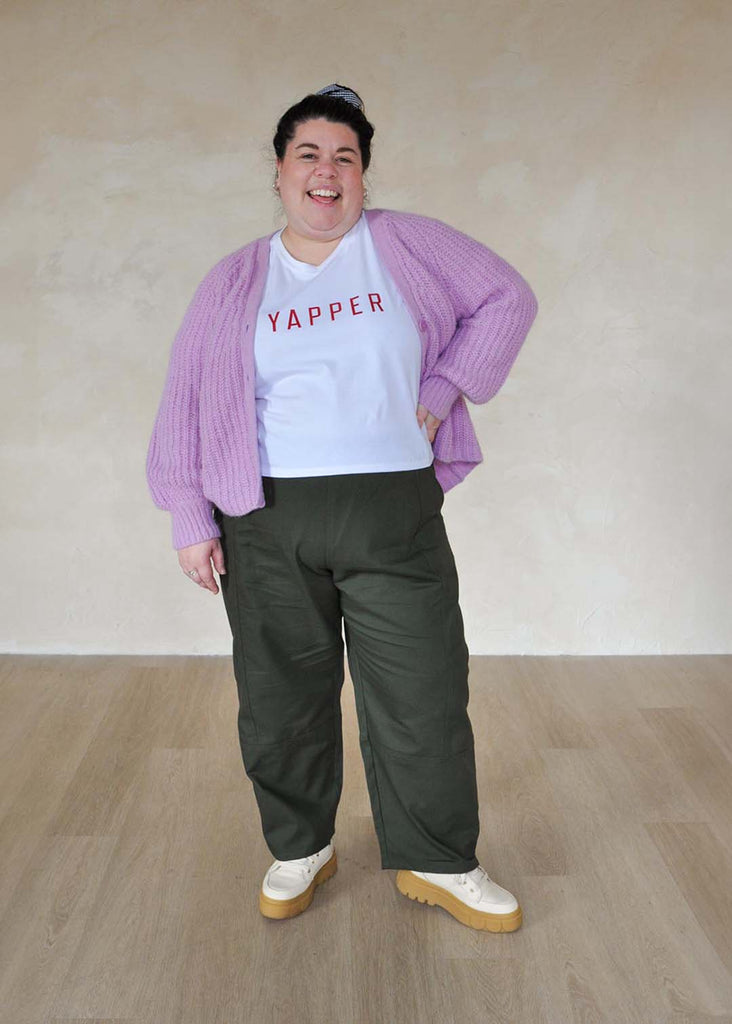 a plus size woman wearing green utility pants