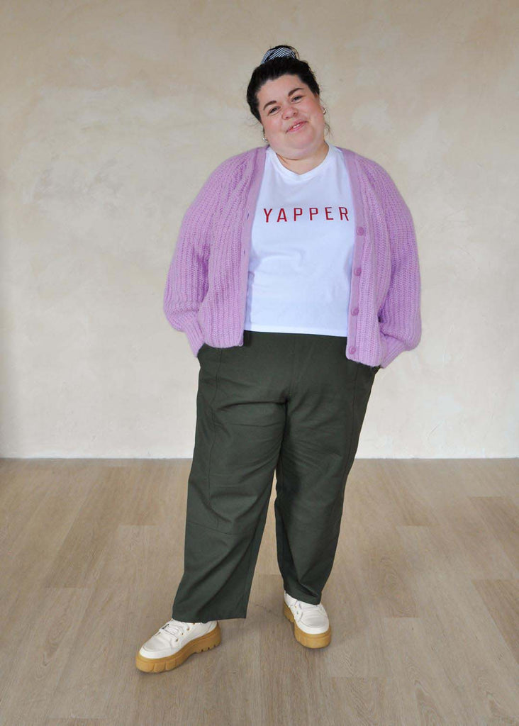 a plus size woman wearing green utility pants