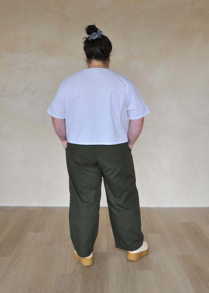 a plus size woman wearing green utility pants