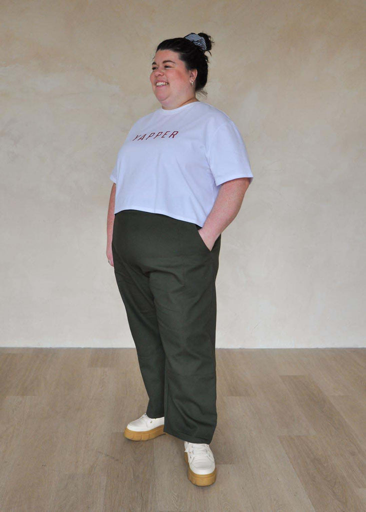 a plus size woman wearing green utility pants