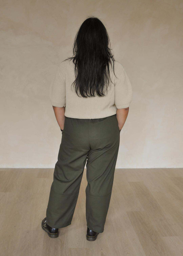 a mid size woman wearing green utility pants