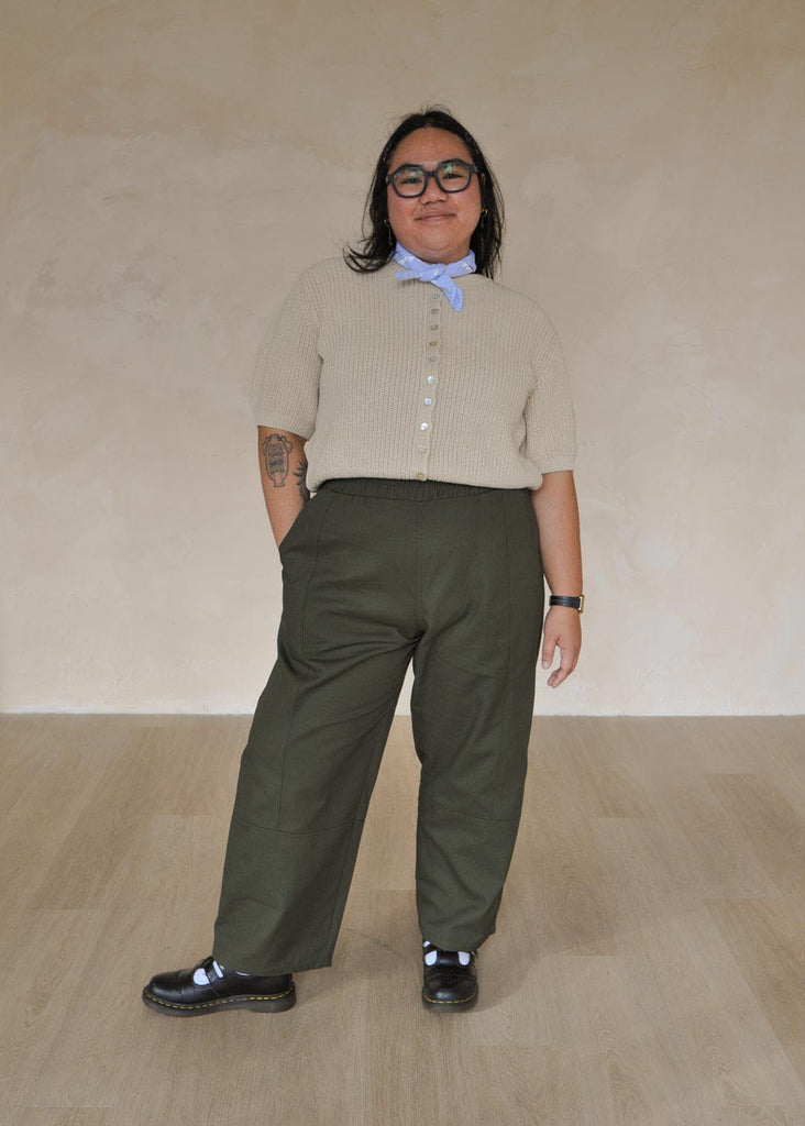 a mid size woman wearing green utility pants