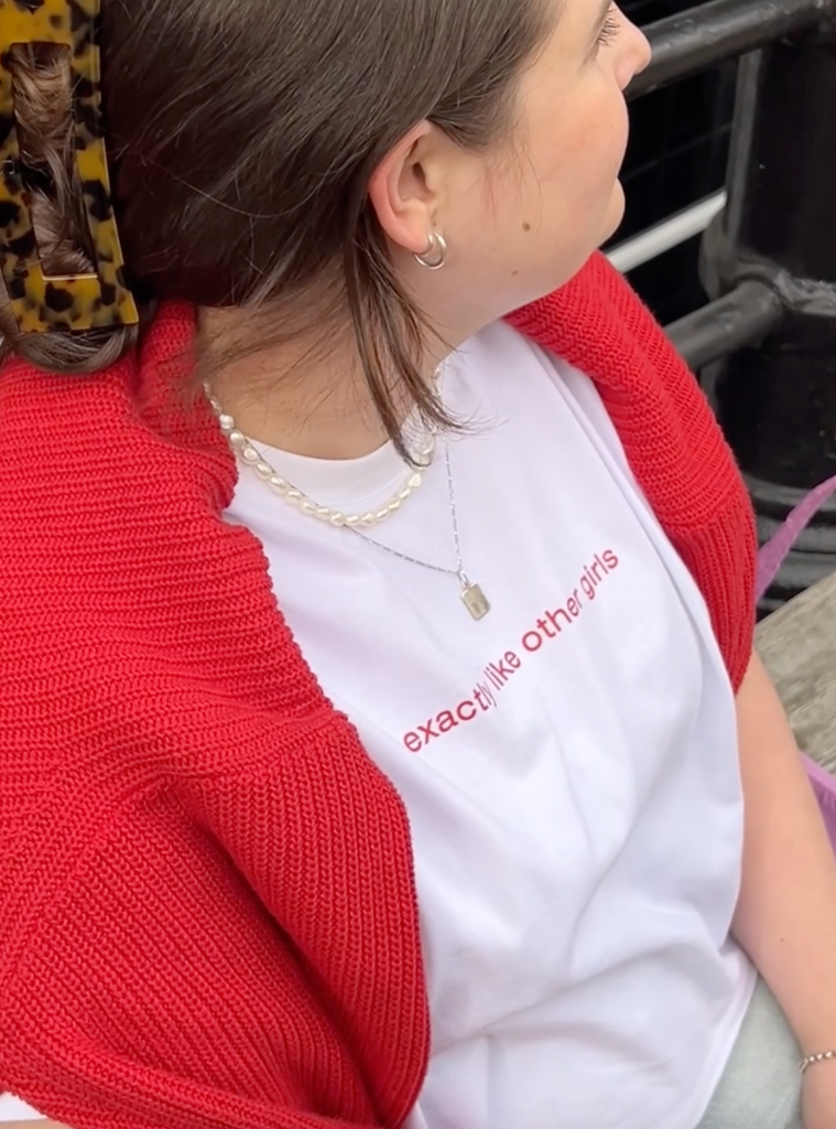 a pan of a plus size woman wearing a white cropped graphic tee