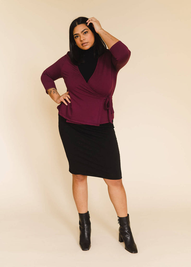 a midsize woman wearing a burgundy wrap top