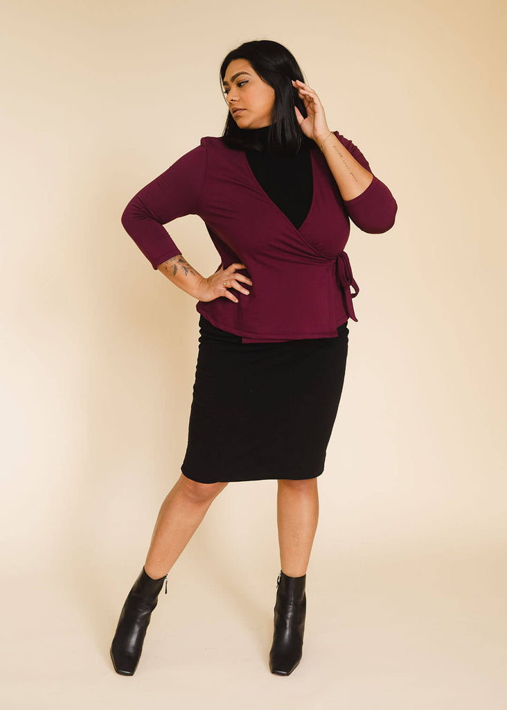 a midsize woman wearing a burgundy wrap top