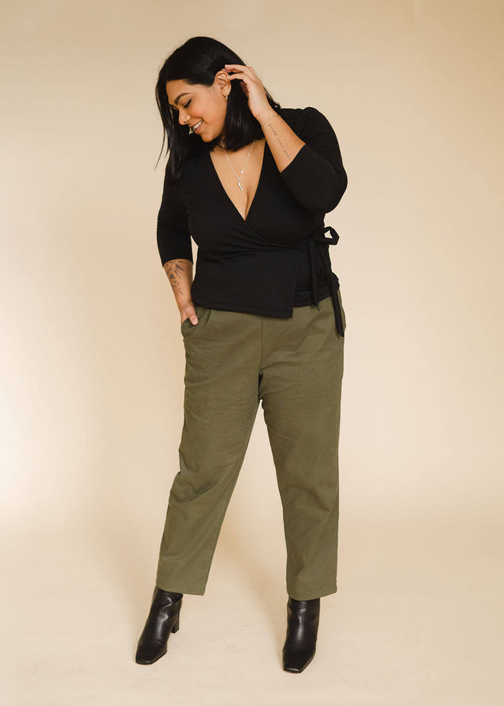 a mid sized woman wearing a black wrap top