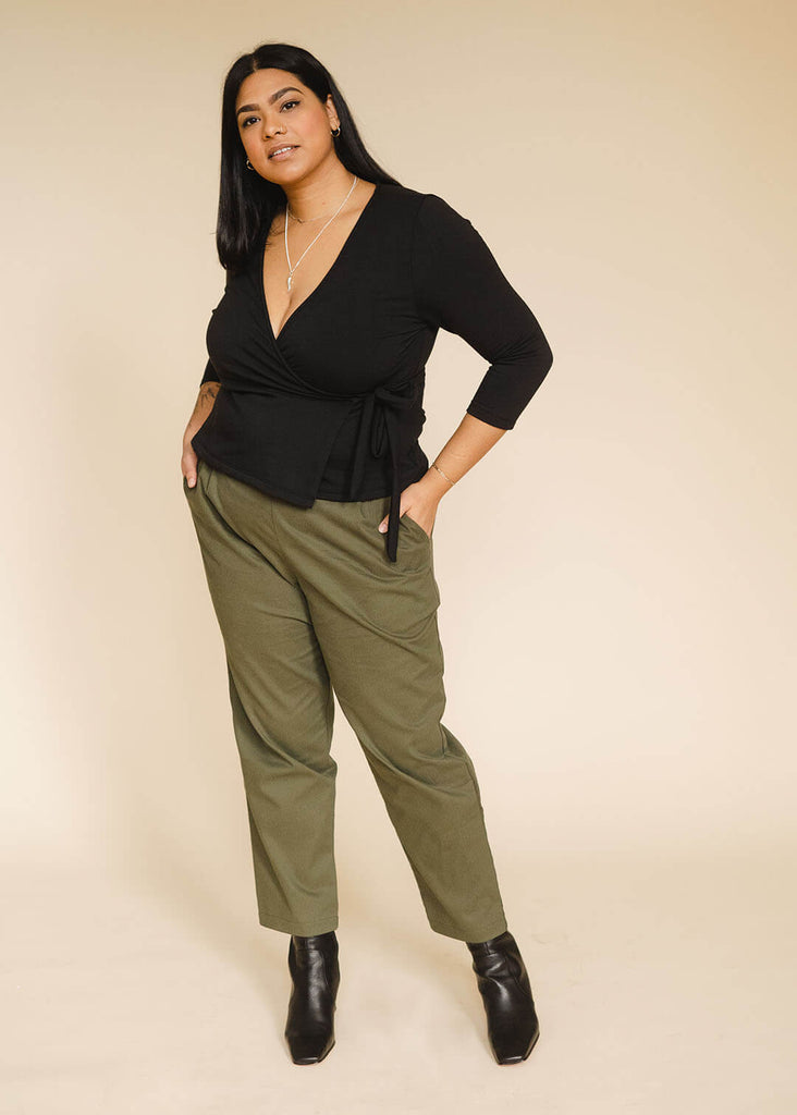 a mid sized woman wearing a black wrap top