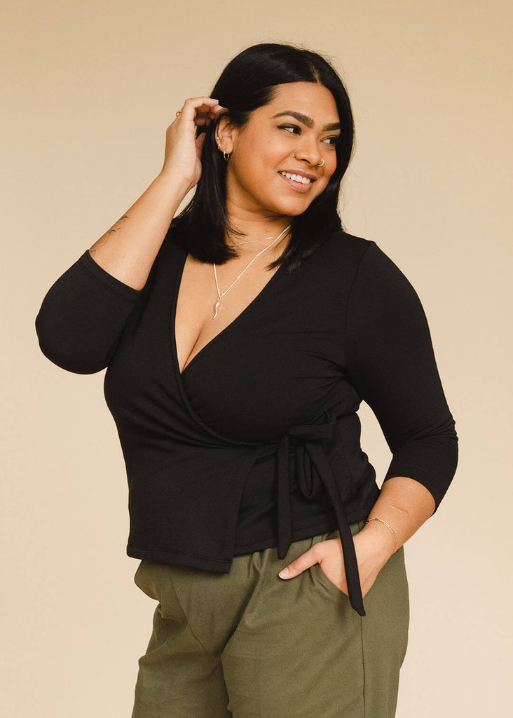 a midsize woman wearing a black wrap top